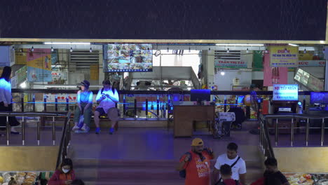 Static-view-of-southeast-asian-market-goers-relaxing-after-long-day-of-shopping