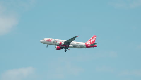 Air-Asia-Airline-Jet-Airplane-Flying-on-Blue-Sky-Background-With-White-Clouds---Tracking