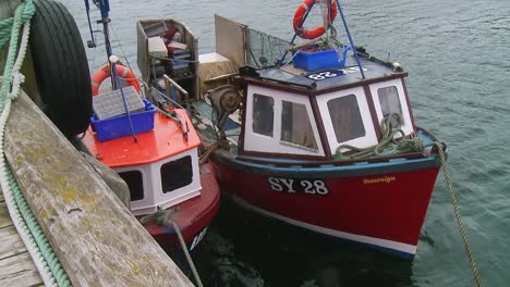 A-shot-of-two-fishing-vessels-docked-on-a-pontoon