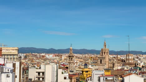 Panoramic-view-of-the-Valencia-skyline-from-a-penthouse-in-the-town-hall-square-on-a-sunny-day-with-mountains-in-the-background