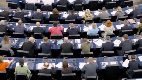 Members-of-the-European-Parliament-voting-during-the-EU-plenary-session-in-Strasbourg,-France---Close-shot,-rear-view