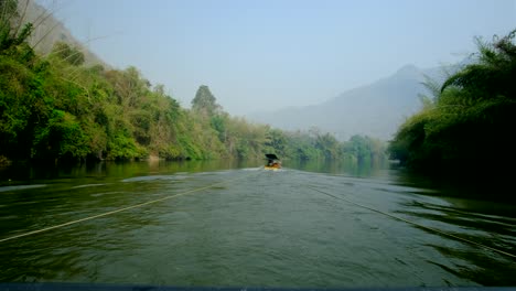 A-boat-cruising-in-the-river-with-a-haze-forest-caused-by-farmers-burning-the-land