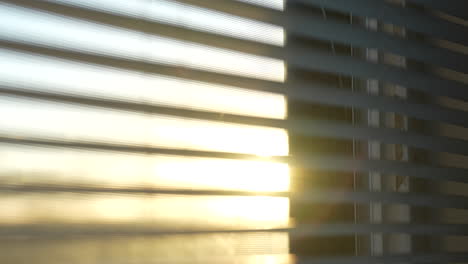 Golden-hour-sunset-through-apartment-window-blinds