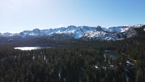 Drone-Flying-Towards-Snowy-Mountains-Over-an-Alpine-Lake-in-Mammoth-Lakes