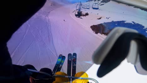POV-perspective-of-a-person-sitting-in-a-ski-lift-and-taking-on-the-sunglasses