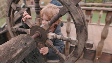 Young-child-playing-pirate-ship-wheel---imagination-playing-make-believe