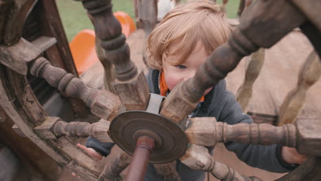 child-playing-with-a-pirate-ship-wheel---imagination-playing-make-believe