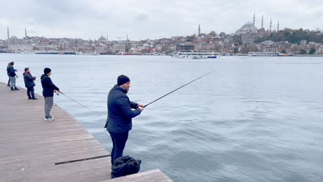 Fishermen-at-Bosporus-in-front-of-Istanbul-Panorama-in-Cold-Winter