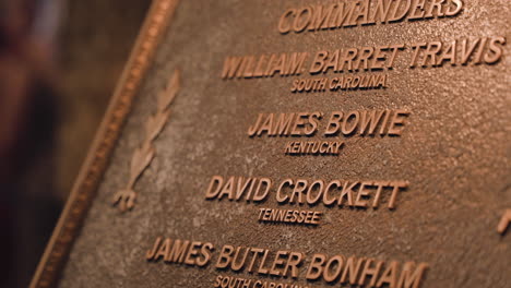 The-Names-James-Bowie-and-David-Crockett-on-a-plaque-inside-the-Alamo