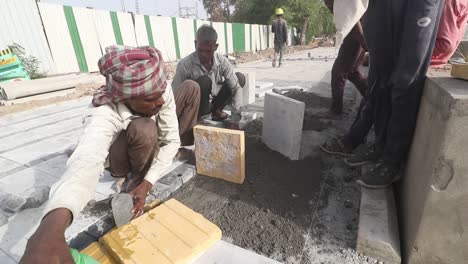 Indian-labourers-working-during-extreme-heat-at-a-footpath-construction-site-near-Pragati-Maida-in-New-Delhi