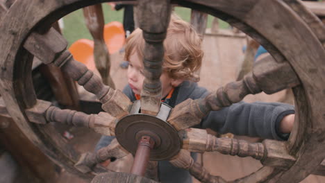Young-child-with-a-pirate-ship-wheel---imagination-playing-make-believe