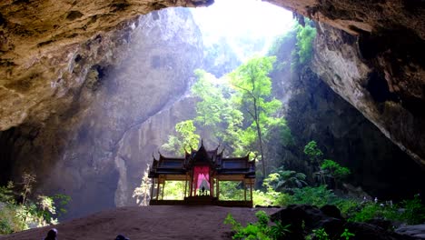 Light-entering-the-cave-with-the-temple-and-people-taking-photographs