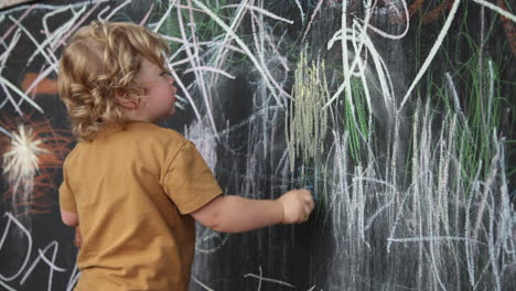 Artistic-toddler-drawing-with-colored-chalk