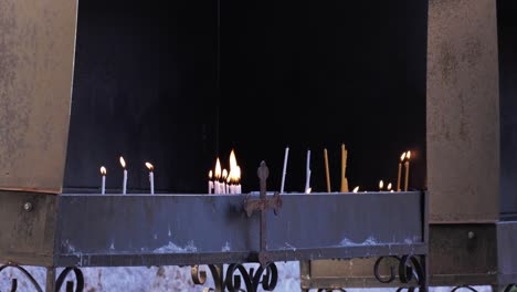 Close-up-of-candle-flames-burning-in-front-of-an-Orthodox-Christian-church