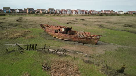 Close-flyover-of-rusted-shipwreck-on-salt-marsh-at-Fleetwood-Marshes-Nature-Reserve