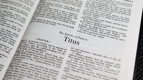 Close-Up-Shot-of-Bible-Page-Turning-to-the-book-of-Titus