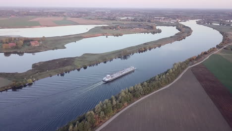 aerial-of-a-cargo-ship-sailing-on-a-river