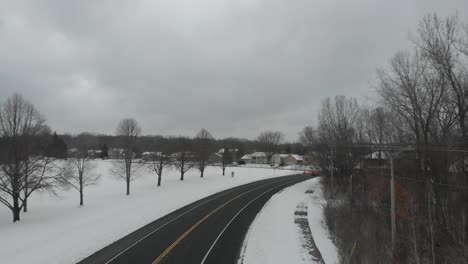 Aerial-view,-county-road-during-a-winter-cloudy-afternoon