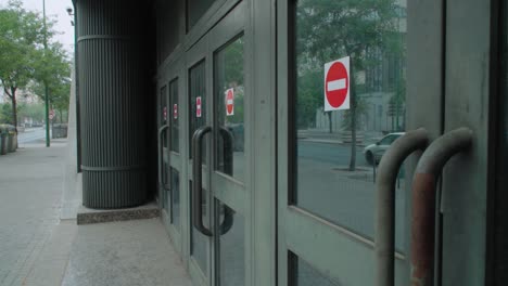 Row-of-doors-with-red-Do-Not-Enter-forbidden-stickers,-Detail-from-Sidewalk