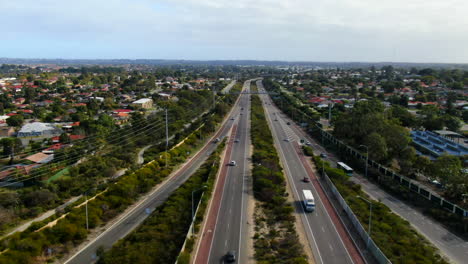 Drone-shot-descends-over-traffic-flowing-through-Erindale-Road-in-Perth-Western-Australia