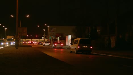 Traffic-on-a-busy-road-at-night-time-in-eastern-suburb-Berlin,-Germany