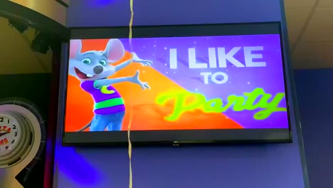 Let's-party-balloon-bouncing-up-and-down-in-front-of-a-colorful-screen-that-says-"I-like-to-party-with-Chuck-E