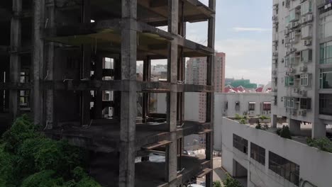 Lowering-boom-drone-shot-of-derelict-building-in-Macau