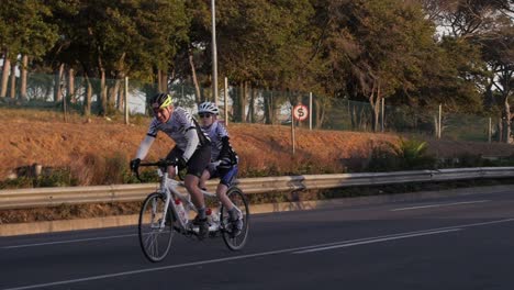 Father-and-young-son-during-the-Cape-Town-Cycle-Tour-on-a-tandem,-Slow-motion