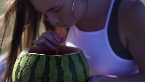 Woman-holding-watermelon-and-drinking-from-it,-having-a-good-time