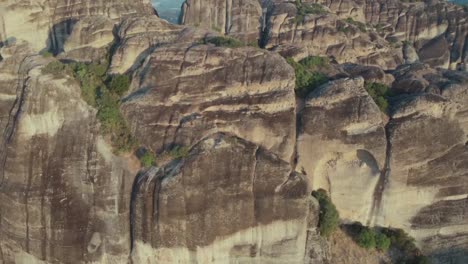 Cinematic-Drone-Shot-flying-over-the-Meteora-Rocks-during-Sunrise-in-Greece