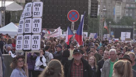 Crowd-of-peopla-with-big-banners-walking-during-demonstration-in-Czech-Republic-against-premier-Andrej-Babis-and-president-Milos-Zeman,-closeup