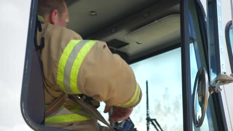 Firefighter-gets-in-firetruck-after-a-firefighting-and-rescue-operation