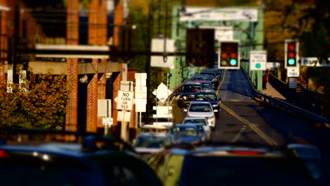 Time-lapsed-shot-of-traffic,-traffic-lights,-pedestrians,-and-bridge