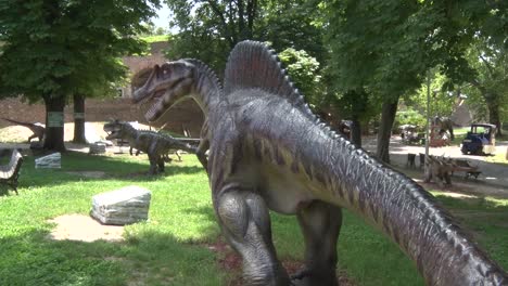 Realistic-spinosaurus-dinosaur-in-dino-park-behind-him