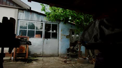 Entrance-to-old-home-workshop-with-rusted-machinery-in-the-front