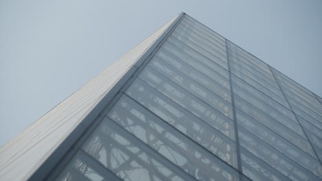 Popular-Louvre-glass-pyramid-museum,-low-angle,-close-up,-rack-focus