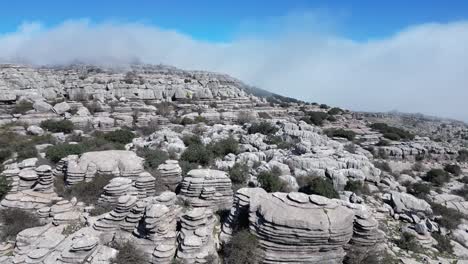 Flying-with-a-drone-through-the-natural-area-of-​​El-Torcal,-a-karst-area-located-in-Antequera-in-the-province-of-Malaga,-Spain
