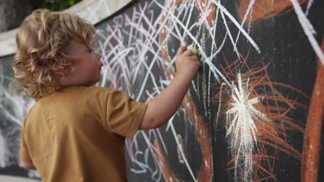 Chalk-drawing-by-a-toddler-outdoors