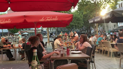 People-eating-in-cologne-restaurant-in-old-town-during-Music-Band-Playing-in-Background
