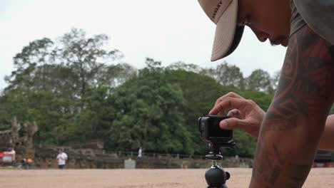 Asian-Man-Setting-up-GoPro-for-Filming-at-Angkor-Wat-HD