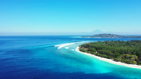 Colorful-seascape-with-green-vegetation-of-tropical-island-surrounded-by-white-sand-of-exotic-beach-and-blue-azure-sea-in-Indonesia