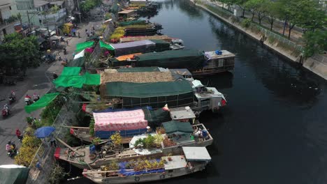 Aerial-view-flying-over-of-floating-flower-market-and-riverbank-in-Saigon-or-Ho-Chi-Minh-City-in-Vietnam