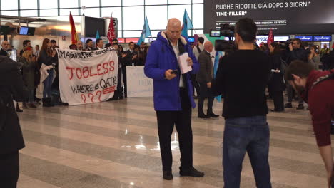 Tv-reporter-at-mobile-phone-at-Air-Italy-protest-for-airline-liquidation