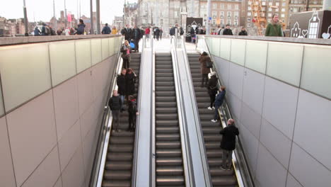 People-On-Escalator-Entering-And-Exiting-At-Amsterdam-Centraal-Station-In-Amsterdam,-North-Holland,-Netherlands