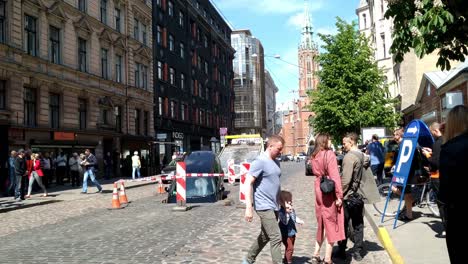 Spectators-filming-a-car-sinked-in-a-street-at-Riga-Latvia