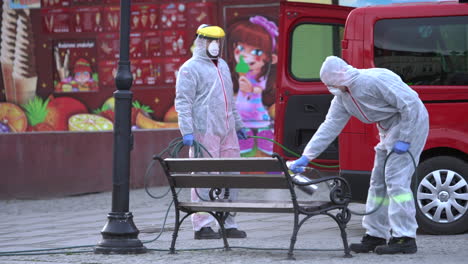 Firefighters-in-protective-uniforms-disinfect-a-city-public-spaces