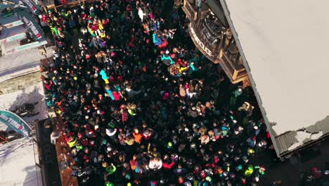 People-partying-at-ski-festival-music-bar,-aerial-view