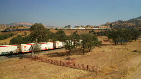 Aerial-view-of-trains-passing-over-the-Mountains-in-Tehachapi-California