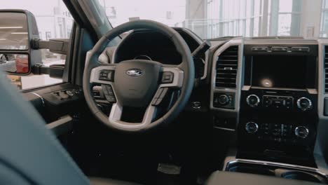 Slow-pan-from-right-to-left-from-behind-the-front-seats-of-a-Super-Duty-Truck-in-the-showroom-of-a-Ford-dealership