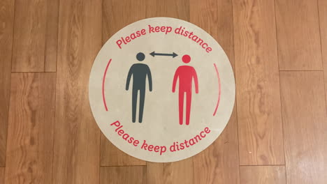 A-sticker-on-the-floor-advises-people-to-maintain-physical-distance